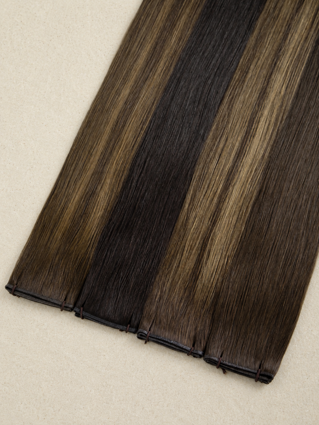 Brown hair extensions on a beige background